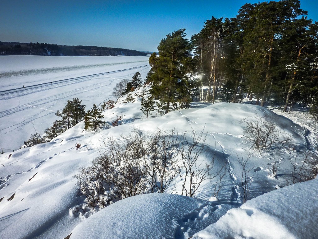 Looking down over a frozen lake that has become a ski track